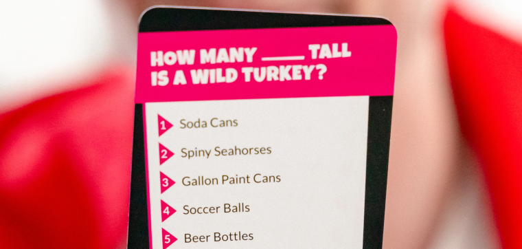 Choose a question card with multiple comparison option to guess how many something tall is a wild turkey